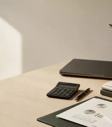 Accounting workspace with calculator and financial reports